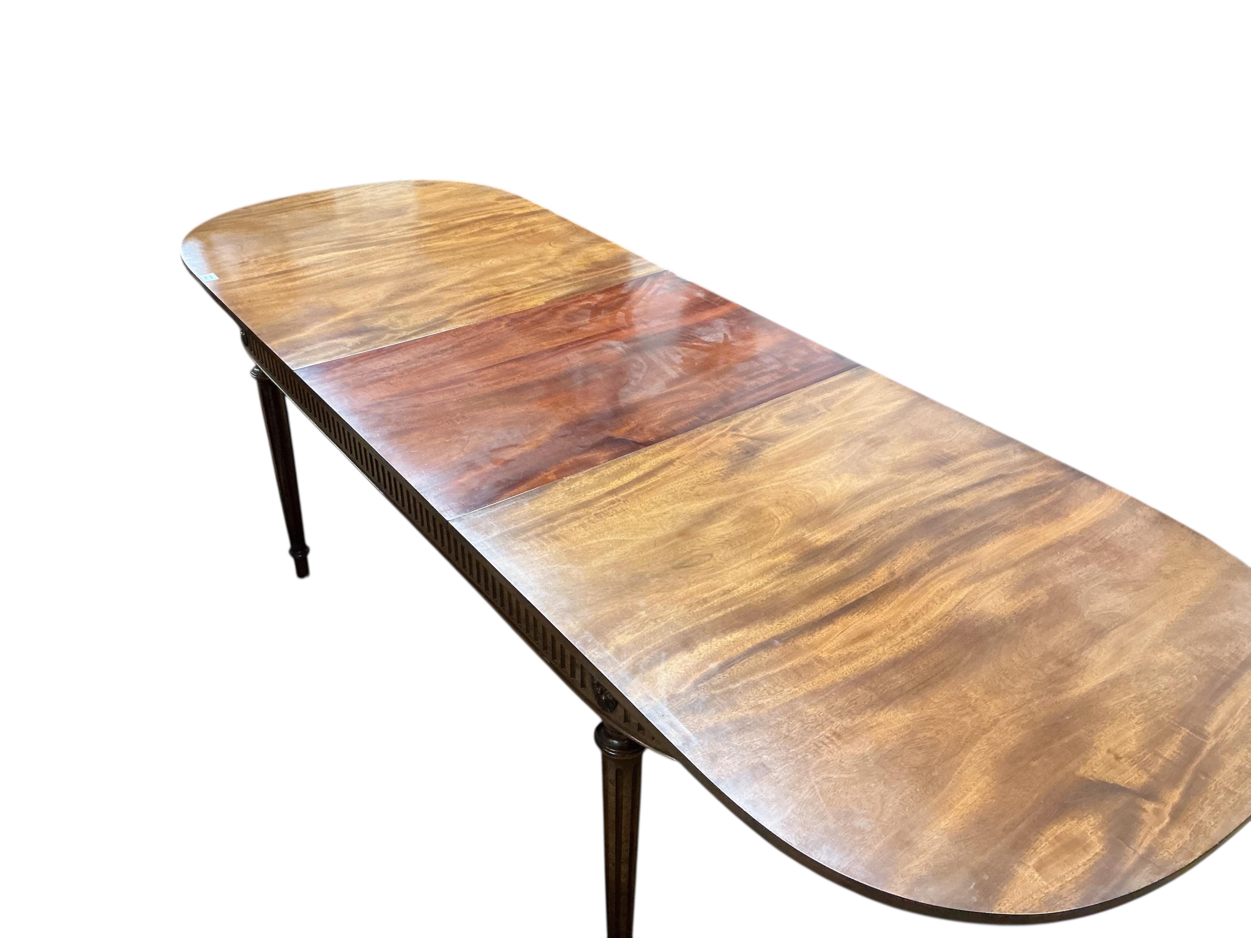 A reproduction Sheraton style mahogany extending dining table, 260cm extended, one spare leaf, width 91cm, height 76cm